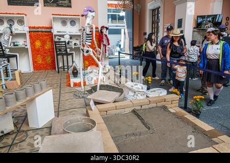 Puebla Mexico,Day of the Dead exhibit,Dia de Muertos Day of the Dead,skeleton figures,art installation,clay pottery display,handmade crafts,orange mar Stock Photo
