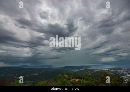 Dramatic thunderstorm over the Adriatic sea near Slovenia’s rocky green coast Stock Photo
