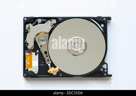An old physical hard drive with read and write head Stock Photo