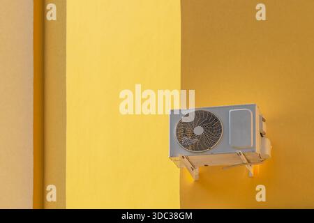 Outdoor unit of a split-system air conditioner on the building's facade. Climate control Stock Photo