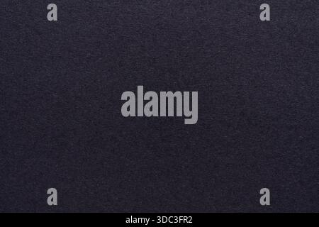 Dark plain black paper texture with fine grain details and matte finish. Stock Photo