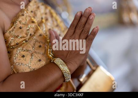 Close up of elderly womans hands, doing the traditional thai hand greetings. High quality photo Stock Photo