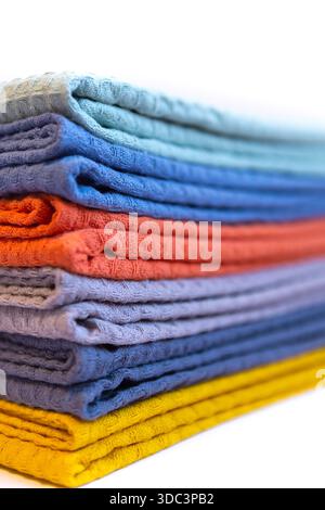 Stack of colorful microfiber towels arranged in a neat pile on a white background. Bright household textiles in assorted colors for cleaning, kitchen Stock Photo