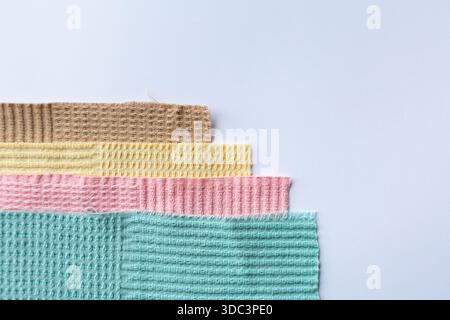 Stack of colorful microfiber towels arranged in a neat pile on a white background. Bright household textiles in assorted colors for cleaning, kitchen Stock Photo