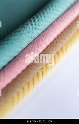 Stack of colorful microfiber towels arranged in a neat pile on a white background. Bright household textiles in assorted colors for cleaning, kitchen Stock Photo