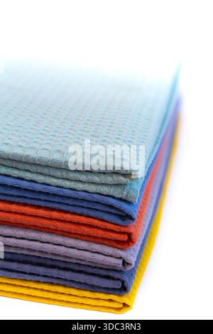 Stack of colorful microfiber towels arranged in a neat pile on a white background. Bright household textiles in assorted colors for cleaning, kitchen Stock Photo