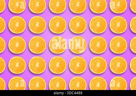 Citrus fruit pattern. Sliced oranges on violet background Stock Photo