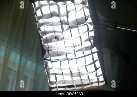 Studio softbox with a grid diffuser is producing soft, controlled light, illuminating the scene and showcasing professional photography and filmmaking Stock Photo