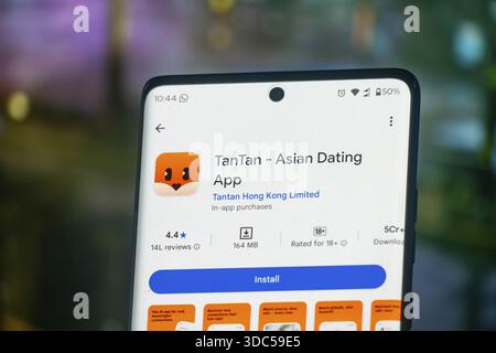 TanTan Asian dating app displayed on a mobile device with a blurred background Stock Photo