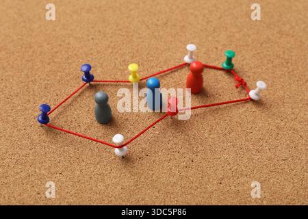 Connected pins with thread on board. Link concept Stock Photo