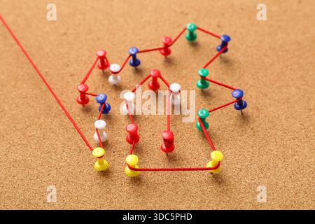 Connected pins with thread on board. Link concept Stock Photo