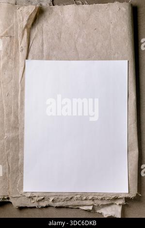 Clean white blank ricae and mulberry paper sheet placed on textured beige craft paper background minimalist composition perfect for mockup designs Stock Photo
