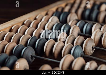 Vintage wooden abacus lying on the wooden table background, close up Stock Photo