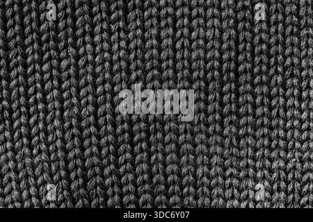 Black striped knitted fabric texture or dark abstract background, close up Stock Photo