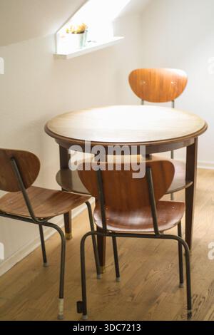 modest dining table and chairs in a student loft in copenhagen Stock Photo
