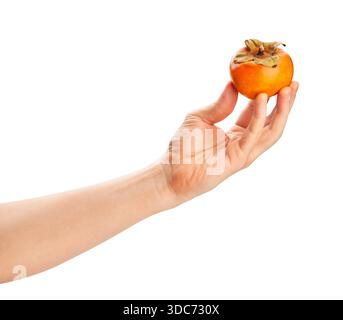 fuyu persimmon in hand path isolated on white Stock Photo