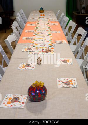 Long table with chairs set for thanksgiving dinner Stock Photo