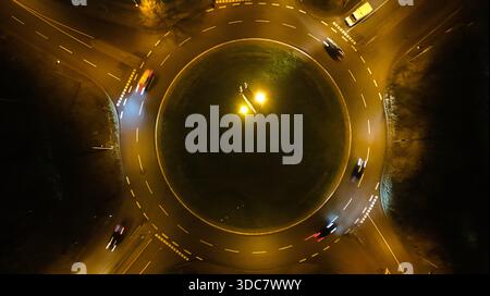 Aerial Night View of Moving Cars with Light Trails on Highway Interchange Stock Photo