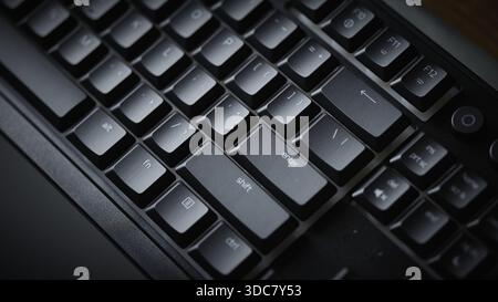 Close-up of Enter and Shift keys on a mechanical gaming keyboard with vibrant green RGB backlight. High quality photo Stock Photo