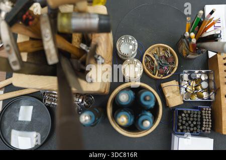 Overhead view of a professional jeweler's workbench with various hand tools and equipment. High quality photo Stock Photo