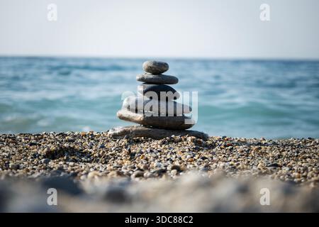 Balanced Zen Stones on a Pebble Beach by the Sea Stock Photo
