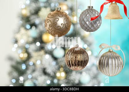 Beautiful Christmas decor hanging against blurred decorated tree. Winter holidays greeting card Stock Photo