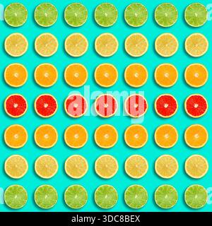 Pattern of sliced citrus fruits on turquoise background Stock Photo