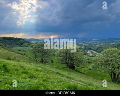 Dramatic Sun Rays Over Rolling Cotswolds Hills, Gloucestershire, England Stock Photo