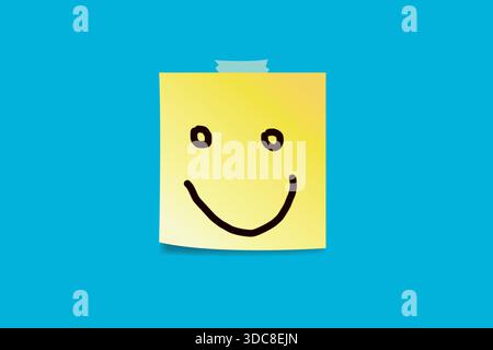 Smiling face drawn on yellow sticky note over blue background Stock Photo