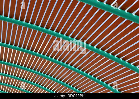 Brown panels intersected by green curved beams abstract textured background Stock Photo