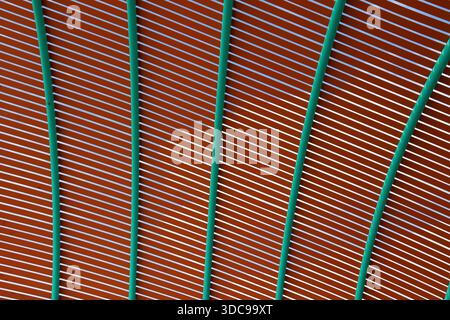 Brown slats and green metal beams abstract textured background Stock Photo