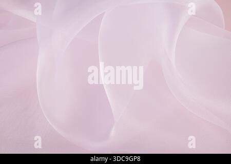 Chic large air waves of white organza on a pink background. stylish wedding background. light airy silk. shine of the fabric Stock Photo