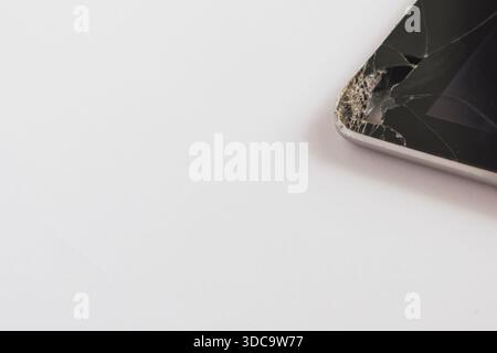 Shattered screen of a tablet computer, revealing the internal components and back cover Stock Photo