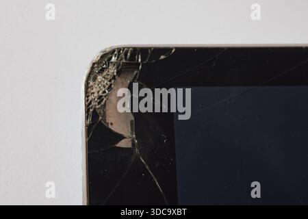 Impact damage: severe crack in a tablet screen showing the components underneath the glass Stock Photo