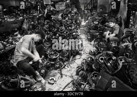Workers in the metal workshop with car engine parts in Bangkok, Thailand Stock Photo