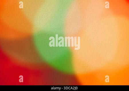 Blurred, festive, multicolored circles with a New Year/Christmas theme on textured watercolor paper.  Red, green, and yellow circles perfect as backgr Stock Photo