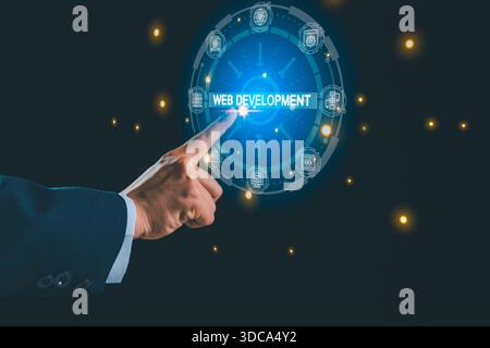 Businessman touching virtual web development interface with digital technology icons, representing modern programming, website creation, software Stock Photo
