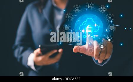 Business professional interacting, glowing cloud computing interface surrounded by technology icons representing data storage, digital transformation Stock Photo