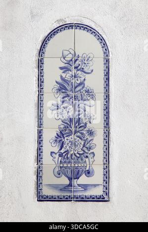 The artwork shows a tall vase filled with flowers, detailed in blue and white tiles. Stock Photo