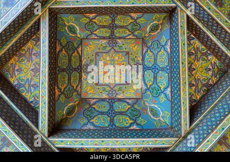 A richly decorated ceiling design featuring a square, layered geometry with ornate floral motifs in vivid blues and greens. The piece showcases symmet Stock Photo