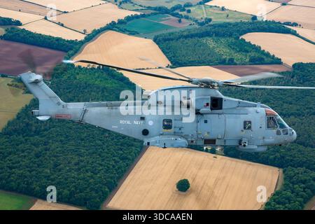 An air-to-air view of a Royal Navy EHI EH101-111 Merlin HM2 helicopter ...