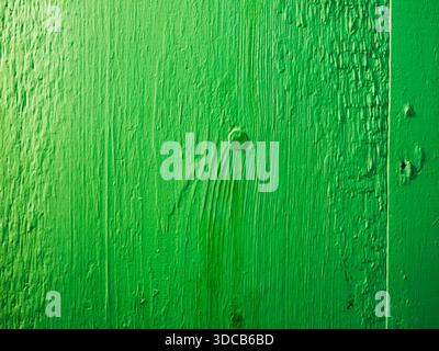 Green painted wood surface showing texture and nail Stock Photo