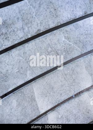 Gray textured surface with parallel black lines Stock Photo