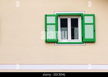 Minimal wall with green window shutters Stock Photo