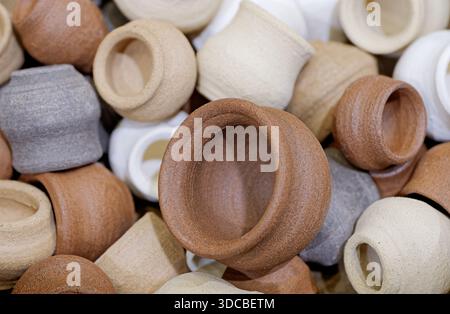 A variety of small toy clay pots of various sizes and colors, close-up shot, abstract background Stock Photo