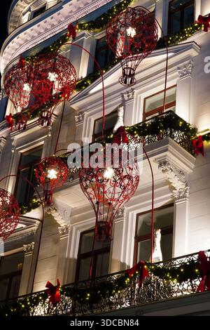 Beautiful historical building facade decorated for Christmas with wrought iron red balloons in center of Bucharest in 2025 Stock Photo