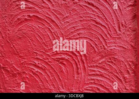 Red textured wall surface with handcrafted abstract pattern Stock Photo