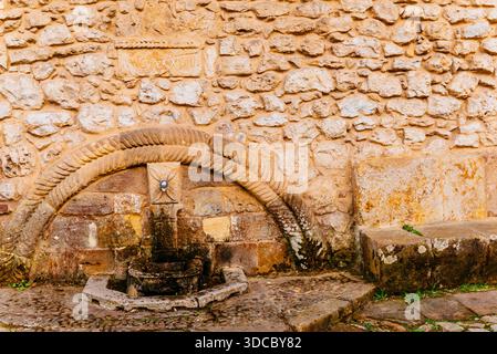 Fountain attached to the wall in the Plaza Mayor - Main Square. It is a stone fountain in the Baroque style from the 17th century, whose decoration co Stock Photo