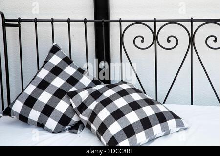 Two Black and White Checkered Pillows on a Bed Stock Photo