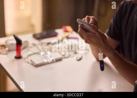 man using otg usb with her mobile phone to copy photos Stock Photo